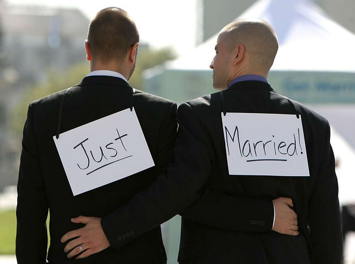 Same-sex couple Ariel Owens (right) and his spouse Joseph Barham walk arm in arm after they were married at San Francisco City Hall June 17, 2008 in San Francisco, California. Same-sex couples throughout California are rushing to get married as counties begin issuing marriage license after a State Supreme Court ruling to allow same-sex marriage.