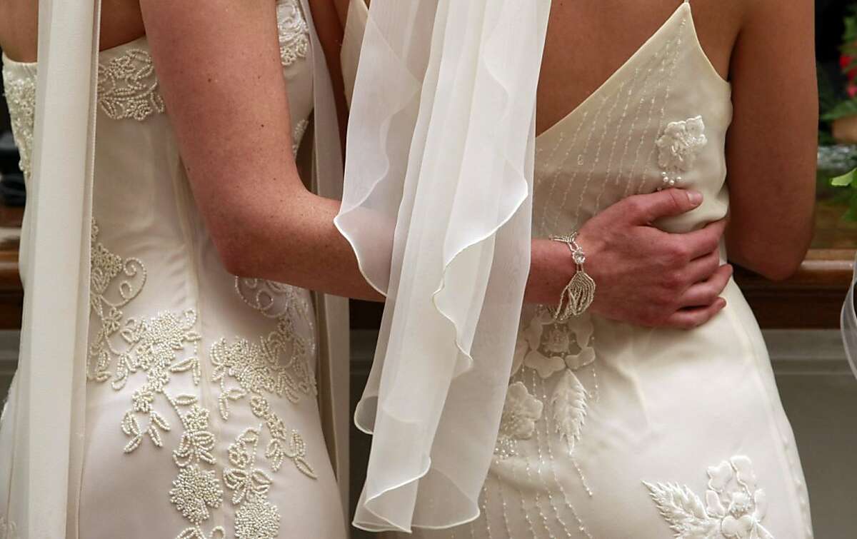 Amber Weiss, left, and Sharon Papo, wait in line in their wedding dresses, to complete paperwork for their marriage certificate at City Hall in San Francisco on Tuesday, June 17, 2008. With a quiet pride and a sense of history, hundreds of gay and lesbian couples across California wed on Tuesday, giving a human face to a landmark court decision and a powerful opening salvo in what is expected to be a bruising fall campaign here over the issue of same-sex marriage.