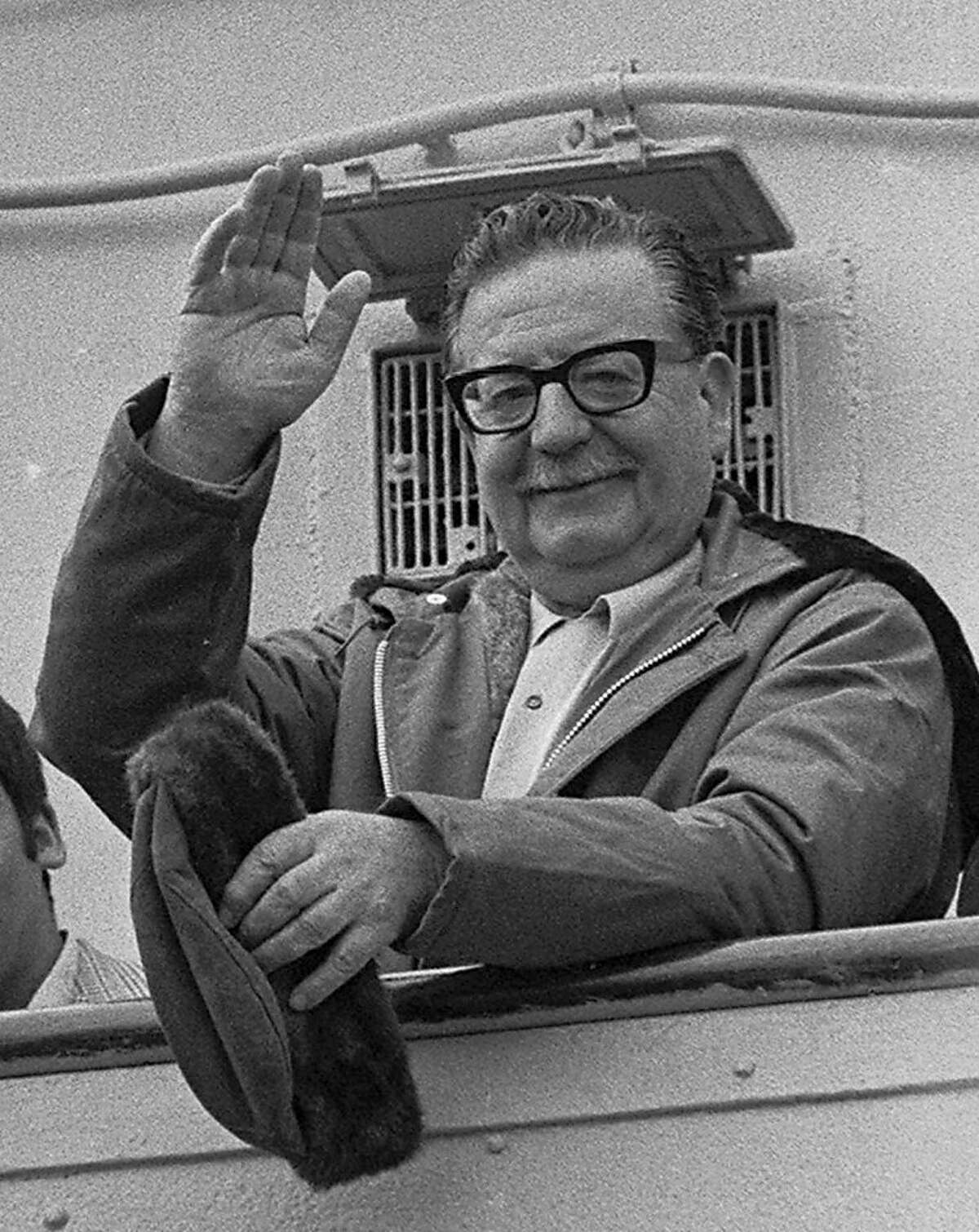 FILE - In this 1971 file photo, President Salvador Allende waves to supporters in Chile. President Sebastian Pinera is being pressured by the daughters of two presidents whose deaths remain shrouded in mystery: Salvador Allende, who allegedly committed suicide as Pinochet's troops seized the presidential palace in 1973, and Allende's predecessor Eduardo Frei Montalva, who had become a prominent Pinochet critic and was allegedly poisoned in 1982.