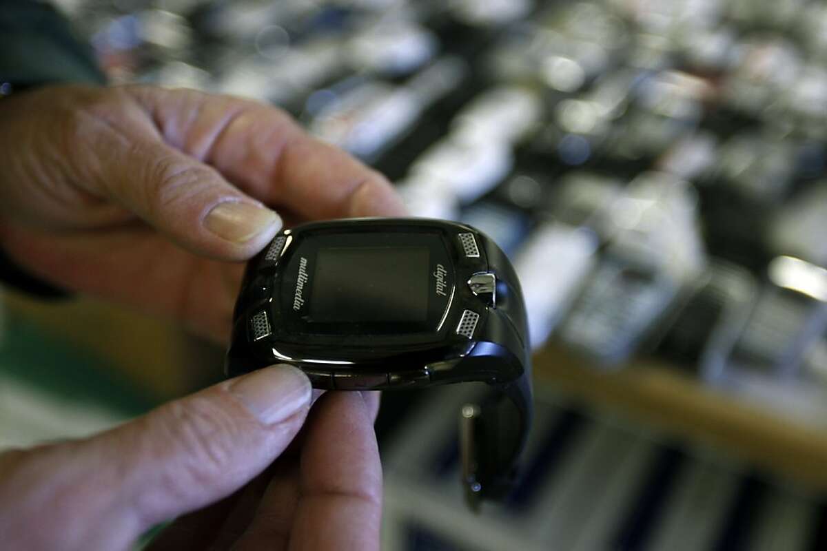 Lt. Robin Bond holds a cellphone wristwatch, one of over 1800 cellphones confiscated from prisoners since 2006, at the California State Prison Solano in Vacaville, Calif., on Wednesday, April 29, 2009.