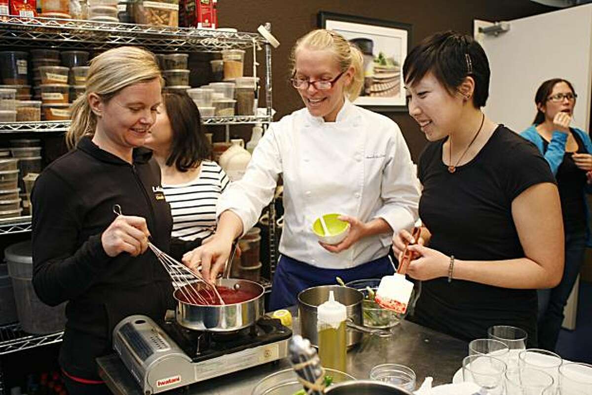 Chef Julieann Moore works with Brighton Miller and Michelle Yu during a Paleo Diet cooking class organized by LaLanne Fitness and Hands on Gourmet in San Francisco Calif, on Friday, March 11, 2011.