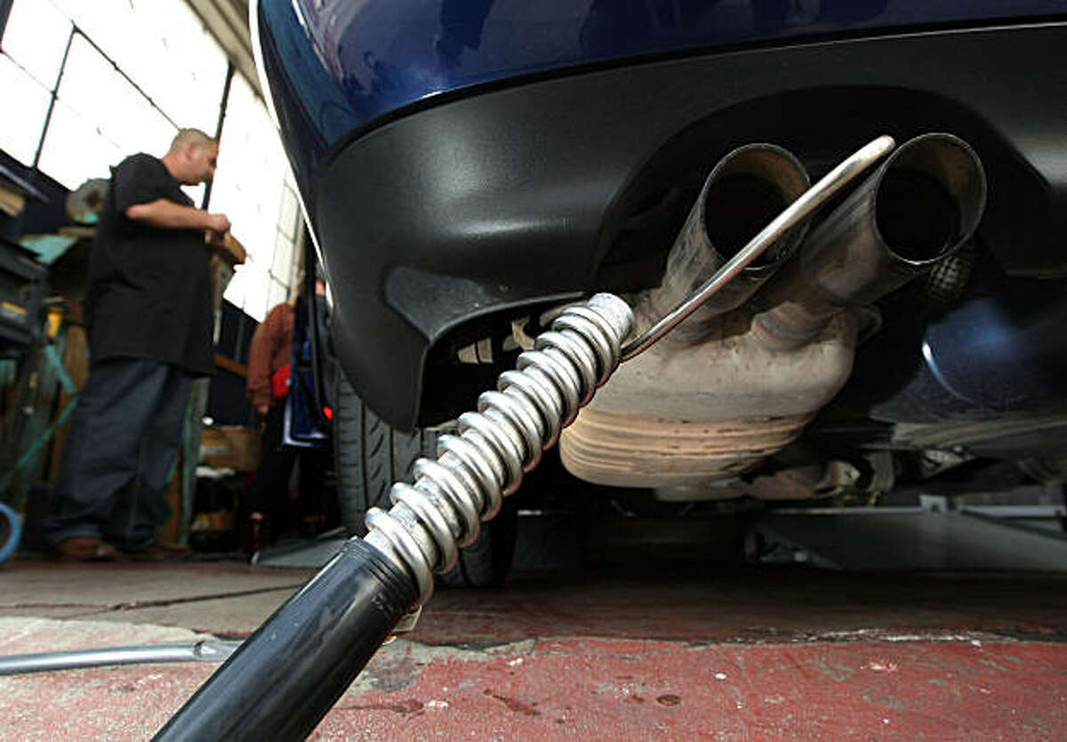 Thomas Zielin monitors a probe that was inserted into the tailpipe of a car while performing an emissions test at Smog Queen May 18, 2009 in San Francisco, California. The Obama administration is expected to announce a plan that calls for raising automobile fuel economy to 35 miles per gallon by 2016 and reducing greenhouse-gas pollution.