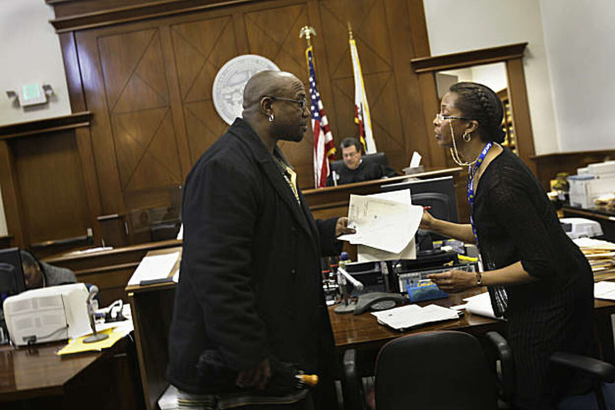 Jimmie Fails of San Francisco collects paper work from Gwendolyn Bates, deputy probation officer, after hearing that his probation is shortened by 2 months after a non-required appearance at the Community Justice Center on Tuesday, March 15, 2011 in SanJimmie Fails of San Francisco collects paper work from Gwendolyn Bates, deputy probation officer, after hearing that his probation is shortened by 2 months after a non-required appearance at the Community Justice Center Court on Tuesday, March 15, 2011 in San Francisco, Calif.