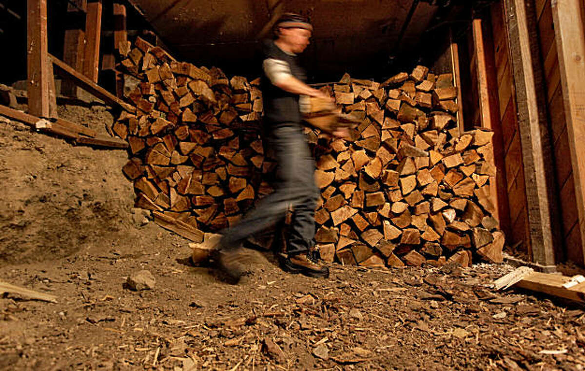 Peter Lehmkuhl, the general manager of the Sierra Club's Clair Tappaan Lodge mountain hostel, in Norden, Ca., on Thursday March, 10, 2011. Lehmkuhl, retrieves wood from the basement storeroom of the lodge where the wood is dried and cut into small pieces to cut down on the amount of smoke released into the air.