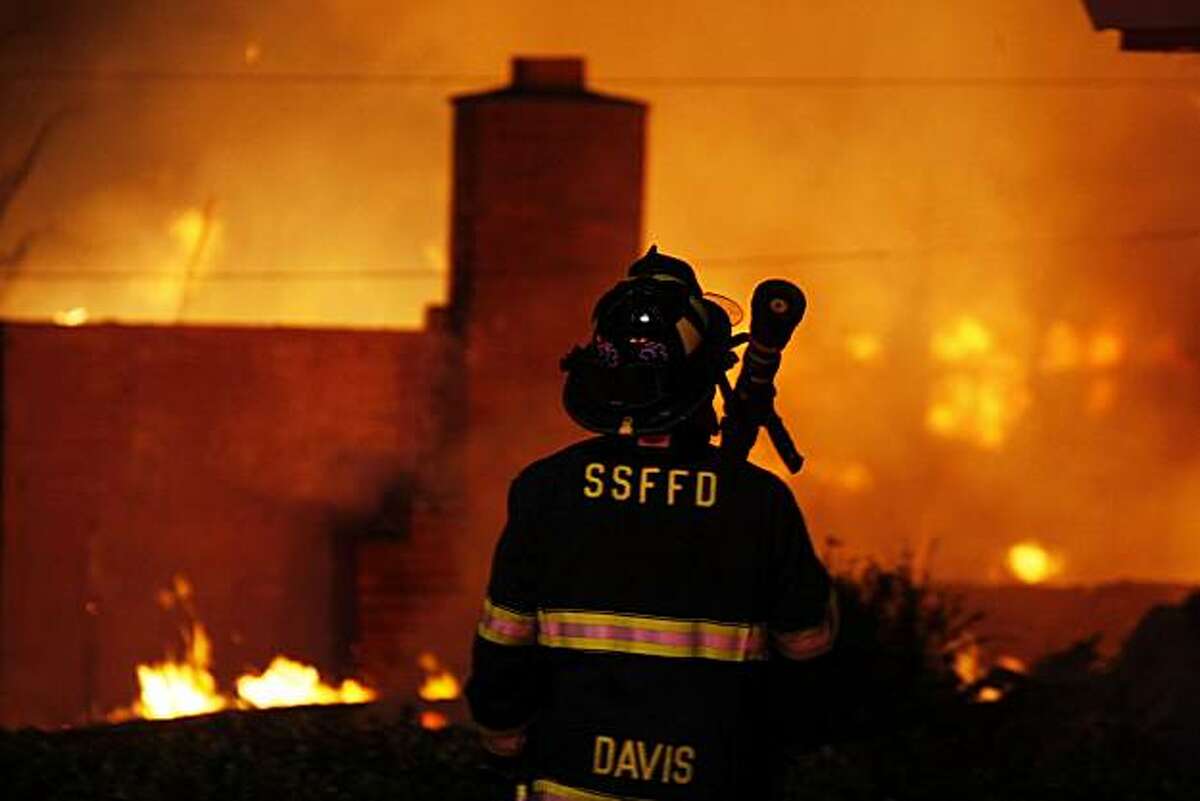 A San Francisco Fire fighter waits for water as he joins other departments from Daily City and San Bruno to fight a massive fire caused by an explosion in a San Bruno neighborhood Thursday, Sept. 9, 2010.