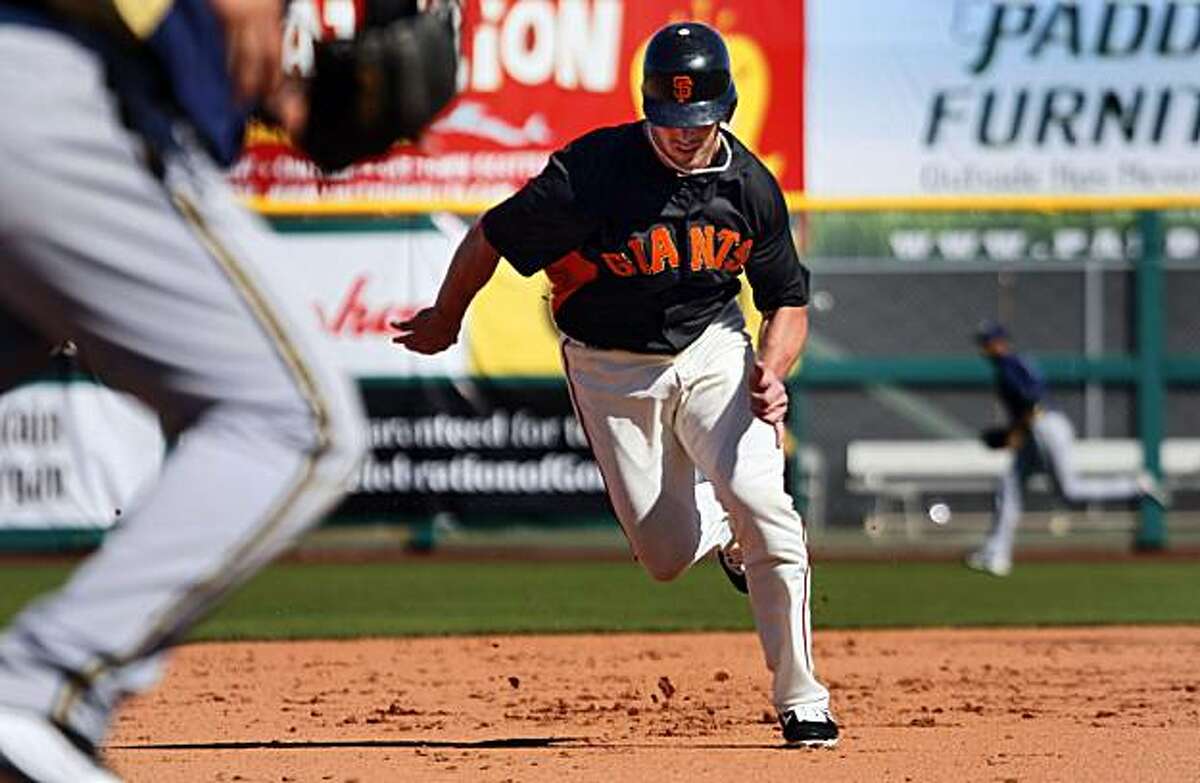 San Francisco Giant Aaron Rowand runs from second base and scores off a Freddy Sanchez base hit in the sixth inning during their game with the Milwaukee Brewers at Scottsdale Stadium in Scottsdale, Ariz. Friday, March 4, 2011.