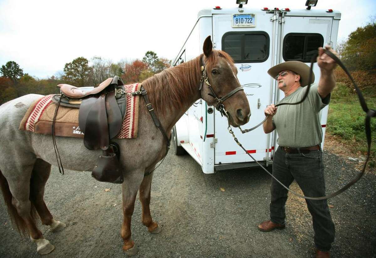 "Kowboy Ken" Forcier of Oxford prepares his horse "Red" for a ride on the Larkin Bridle Trail in Oxford.