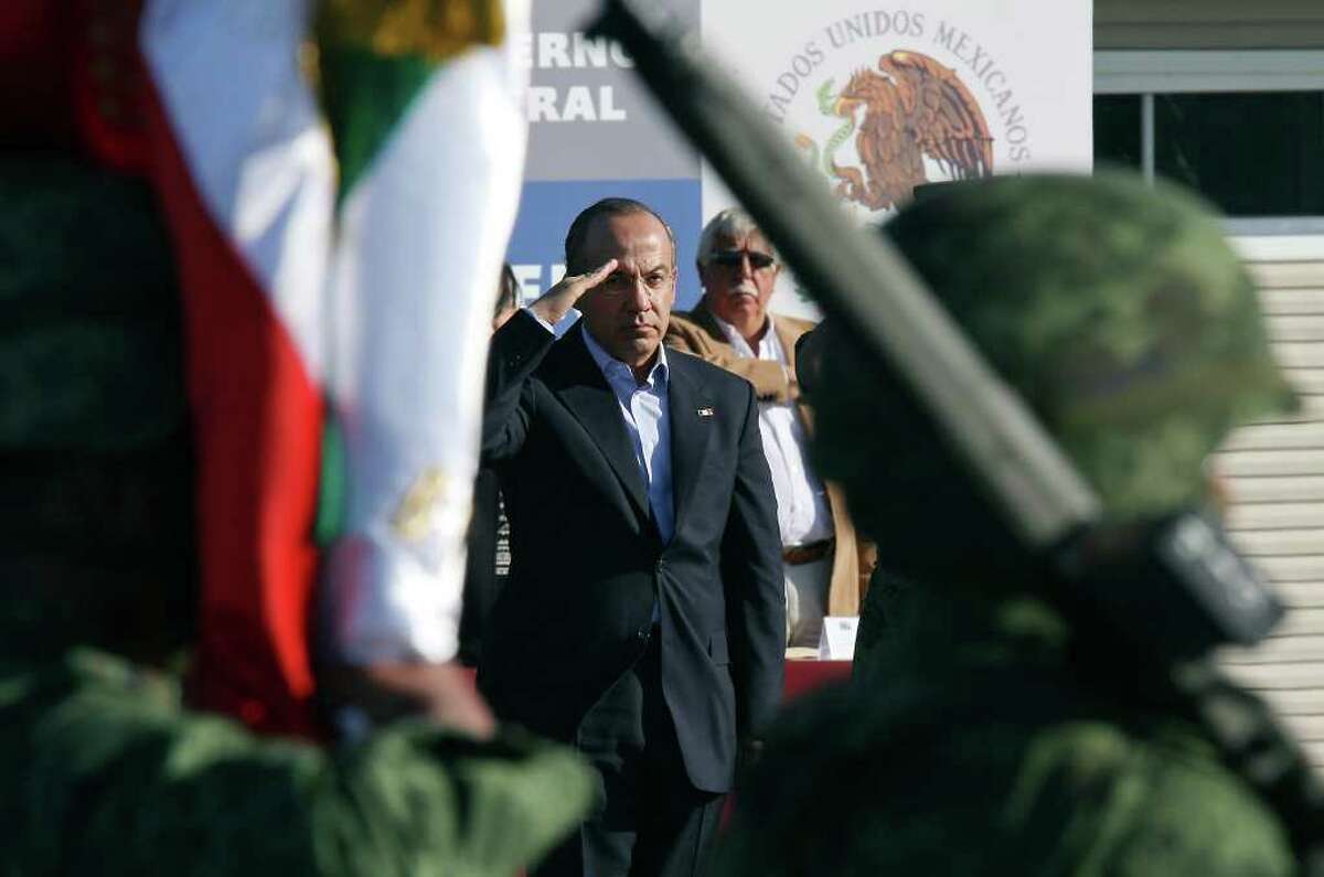 Mexican President Felipe Calderón salutes during a dedication ceremony for a new army barracks in Ciudad Mier in Tamaulipas state.