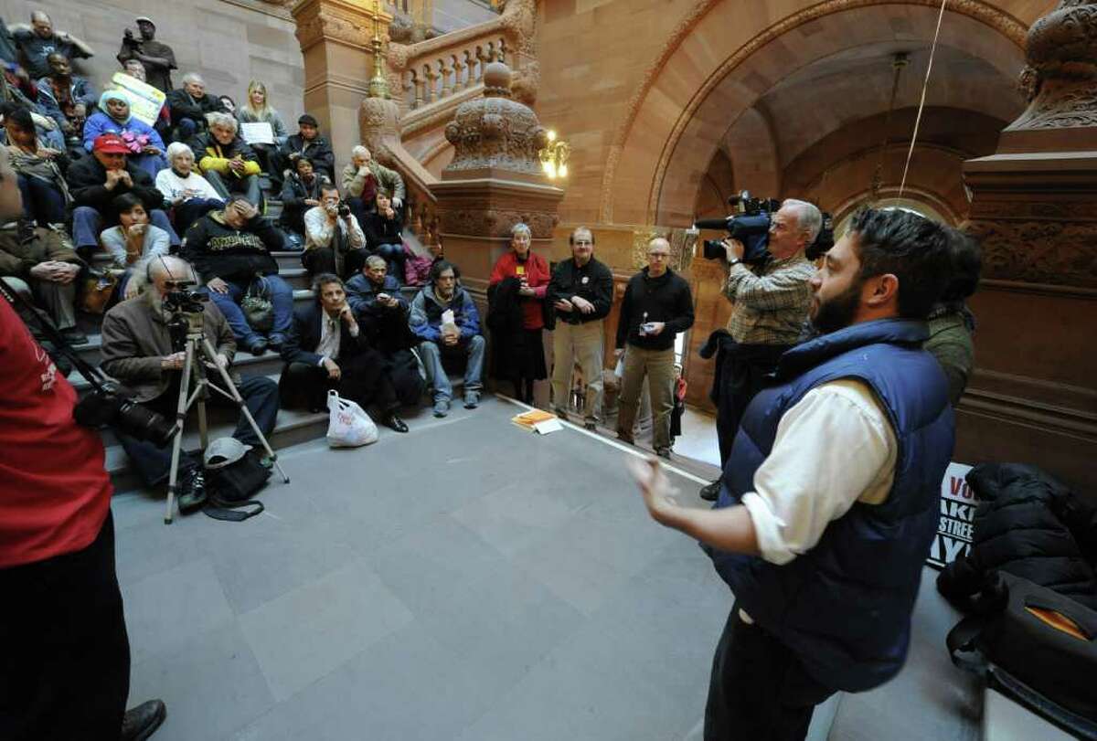 SUNYA student and Occupy Albany member Colin Donnaruma, right leads a discussion of "The Real Rent Reform" campaign on the steps of the Million Dollar staircase in the State Capitol in Albany, N.Y. Dec. 8, 2011. (Skip Dickstein/Times Union)