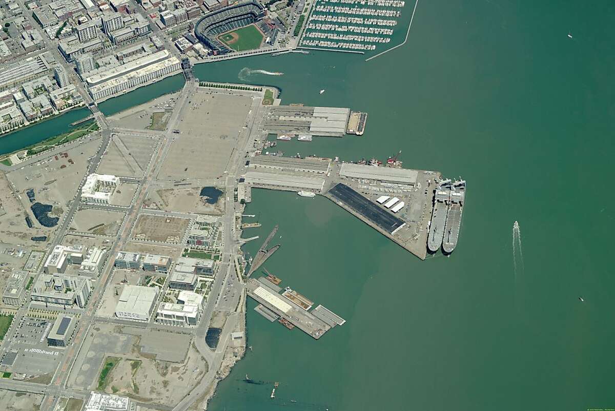 Aerial image of piers 48 and 50 may be the epicenter of the 2013 America's Cup. Mayor Gavin Newsom introduces a binding agreement the city has hammered out with AmericaÕs Cup organizers to host the 2013 regatta in San Francisco. If approved by the Board of Supervisors, the deal provides a concrete commitment by the city to host the cup if Oracle billionaire Larry Ellison agrees to hold it here. That decision is expected by the end of the year, but things look very good for San Francisco if the city approves a deal that the team has been intimately involved in crafting. Ran on: 11-10-2010 Photo caption Dummy text goes here. Dummy text goes here. Dummy text goes here. Dummy text goes here. Dummy text goes here. Dummy text goes here. Dummy text goes here. Dummy text goes here.###Photo: cup10_PH_aerial20###Live Caption:Aerial image of piers 48 and 50 may be the epicenter of the 2013 America's Cup. Mayor Gavin Newsom introduces a binding agreement the city has hammered out with America?s Cup organizers to host the 2013 regatta in San Francisco. If approved by the Board of Supervisors, the deal provides a concrete commitment by the city to host the cup if Oracle billionaire Larry Ellison agrees to hold it here. That decision is expected by the end of the year, but things look very good for San Francisco if the city approves a deal that the team has been intimately involved in crafting.###Caption History:Aerial image of piers 48 and 50 may be the epicenter of the 2013 America's Cup. Mayor Gavin Newsom introduces a binding agreement the city has hammered out with America Ran on: 11-10-2010 Photo caption Dummy text goes here. Dummy text goes here. Dummy text goes here. Dummy text...