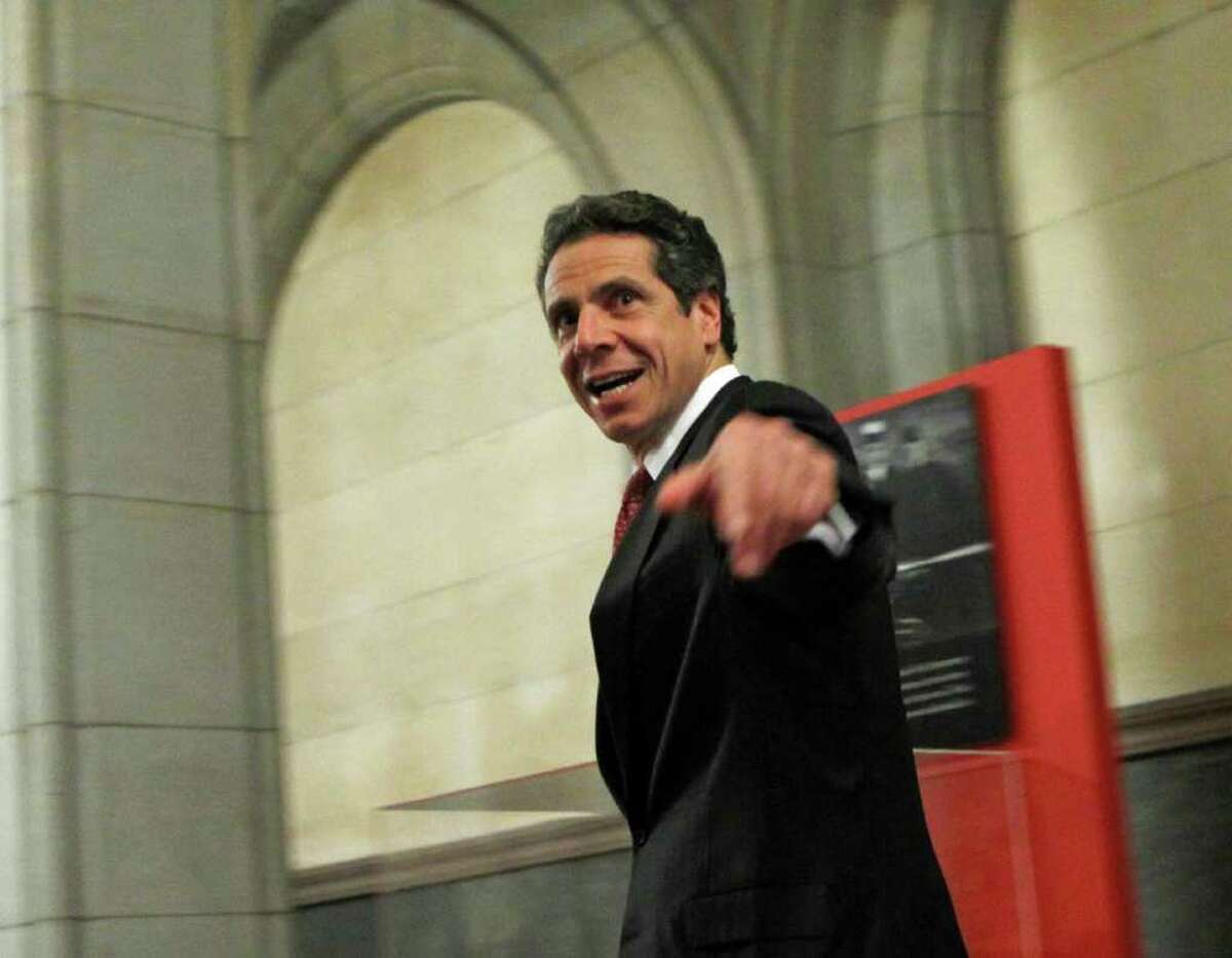 New York Gov. Andrew Cuomo leaves the Capitol in Albany, N.Y., on Tuesday, Dec. 6, 2011. Cuomo and legislative leaders agreed to income tax cuts for New Yorkers making $40,000 to $300,000, which will save most middle-class families $300 to $400 a year. The tax cut of a fraction of 1 percentage point will be funded by an increase in the rate for taxpayers making more than $2 million a year. Those highest earners will pay an 8.2 percent rate, compared to the 6.85 percent rate they would have paid beginning Jan. 1 after a temporary surcharge expires on Dec. 31. (AP Photo/Mike Groll)