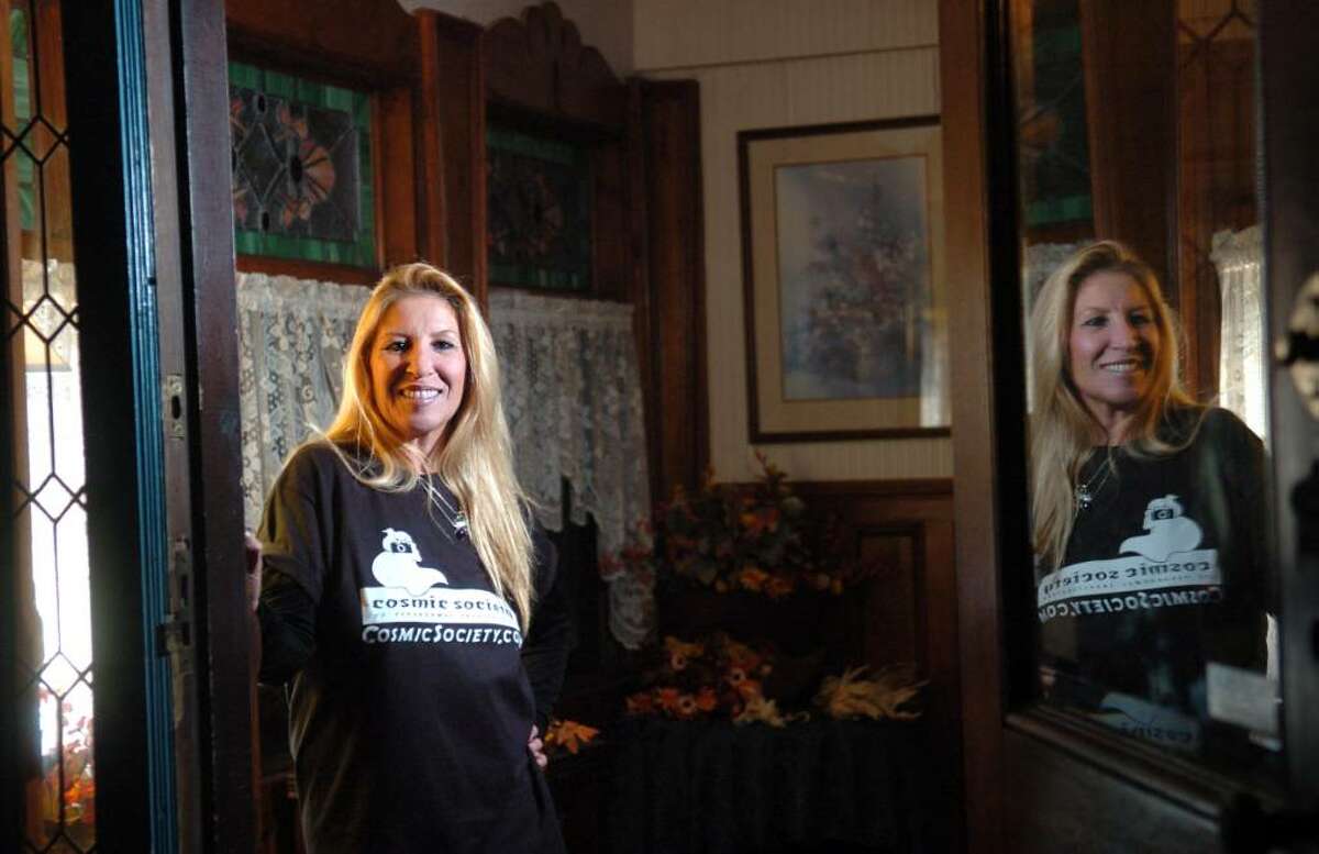 Donna Kent, founder of The Cosmic Society of Paranormal Investigation and author of "Ghost Stories and Legends of Southwestern Connecticut," poses in the doorway of Seymour's Carousel Gardens, an historic Victorian mansion and one-time restaurant known for paranormal activity.