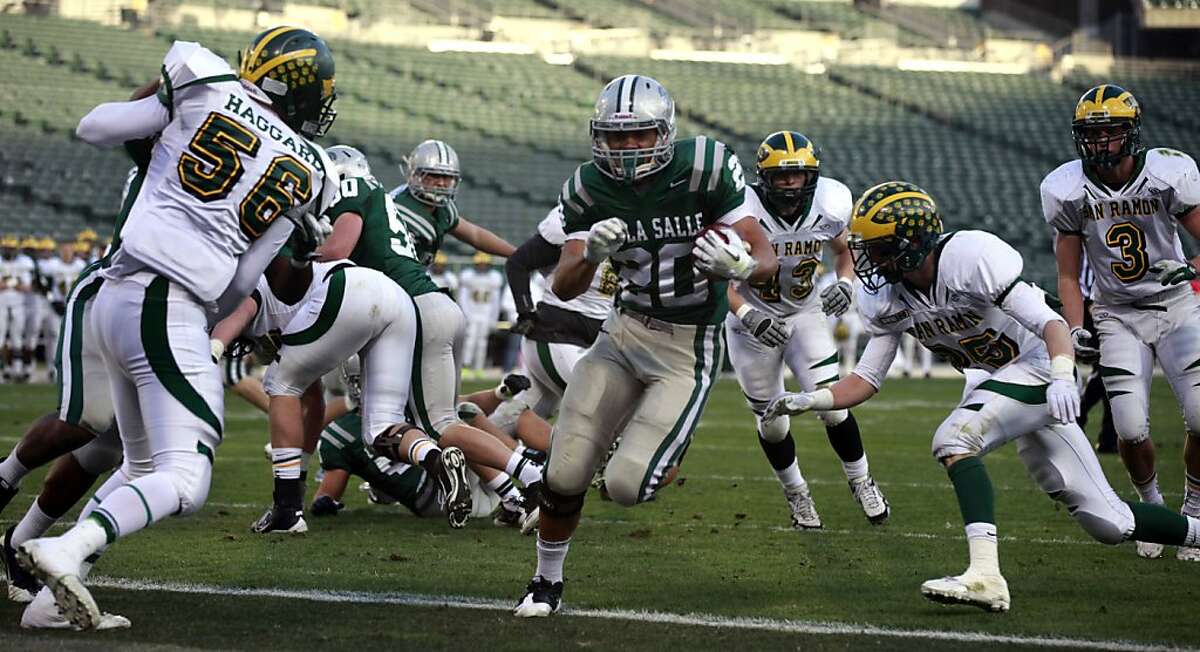 De La Salle Tiapepe Vitale runs into the end zone for a first quater touchdown. De La Salle won the North Coast Section Division one title over San Ramon Valley 49-13 Saturday December 10, 2011 at the Oakland Coliseum.