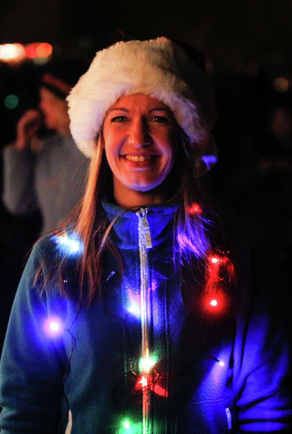 Sarah Jane wears festive lights at the Green Lake Pathway of Light celebration at Green Lake Trail in Seattle on Saturday, Dec. 10, 2011. She has been coming for the last 17 years, each year thousands gather to walk around the lake and listen to holiday performances. Many people wear holiday lights or adorn their dogs in them and walk around the lake. This event has been held in Seattle for the past 35 years.