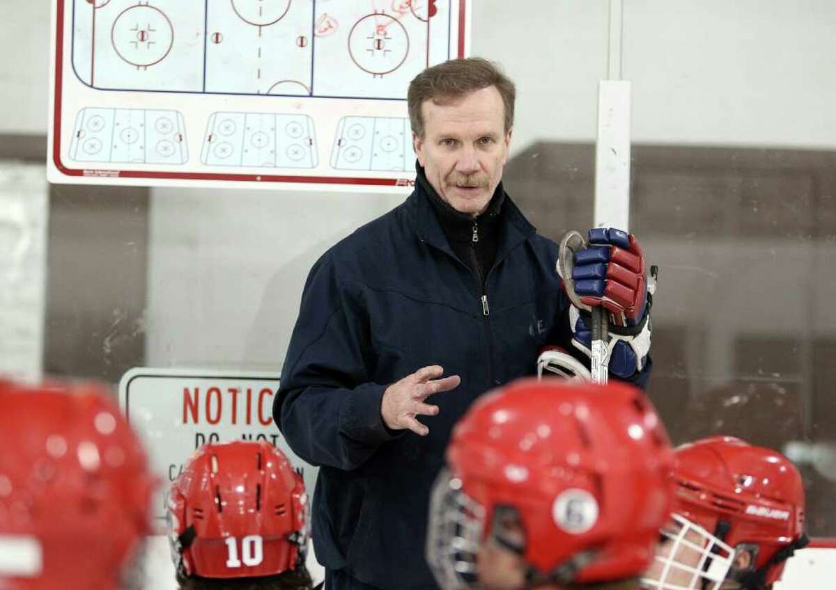 Greenwich High School Boys Varsity Hockey Coach Bob Russel discusses offensive stragedy with his players during a practice session at Dorothy Hamill Rink in Greenwich Monday night. The Cards open up their season on December 15th. © J. Gregory Raymond