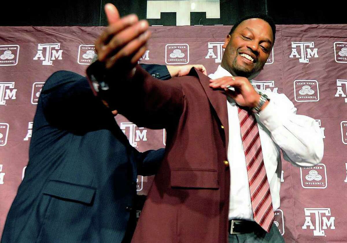 DAVE McDERMAND: ASSOCIATED PRESS MAROON MOMENT: Newly appointed Texas A&M football coach Kevin Sumlin, right, is outfitted in his team's colors Monday.