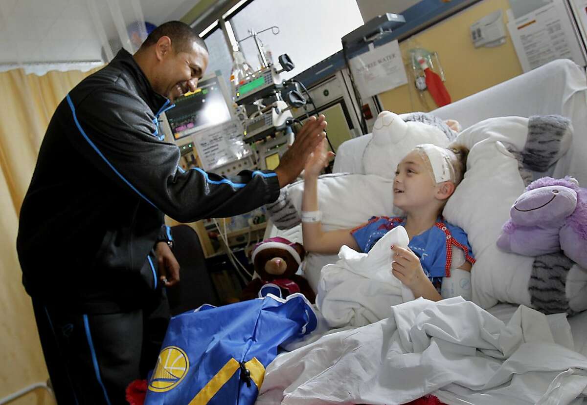 Coach Mark Jackson got a nice greeting from Elissa Loock, 9 years, from Lodi, Calif. New Golden State Warriors coach Mark Jackson and forward Dorell Wright payed a visit to the pediatric oncology unit at the Kaiser Permanente Medical Center in Oakland Calif. Monday December 12, 2011.