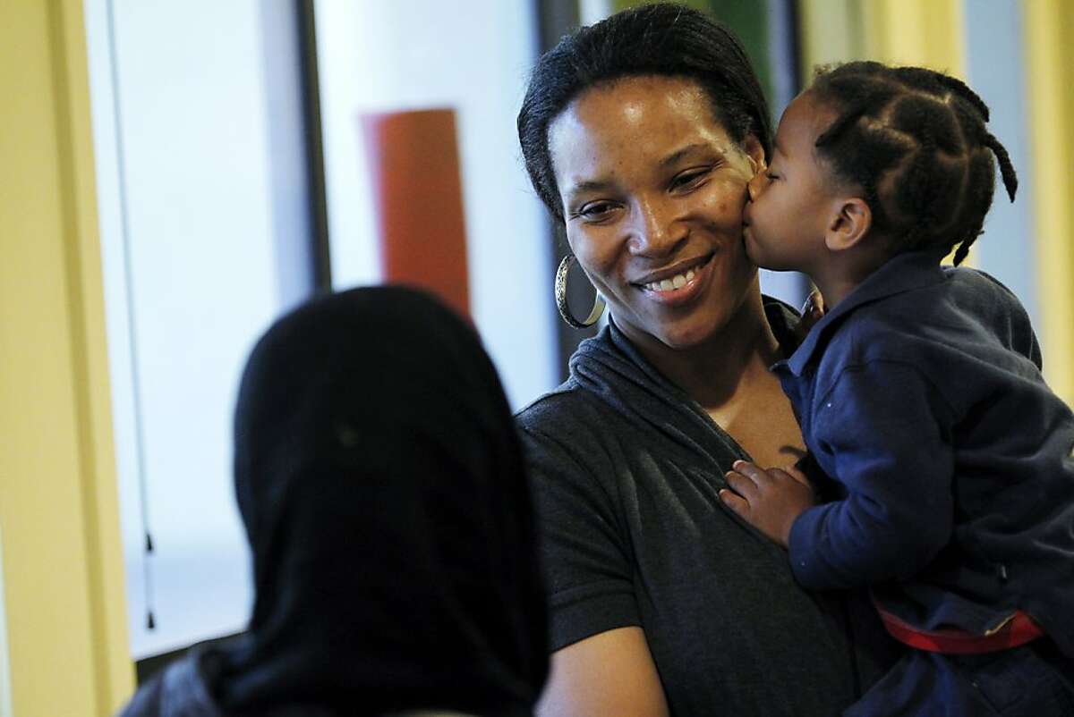 Kenya Anthony, of Oakland, receives a kiss from her son Favel Raynor (2) at Martin Luther King Jr. Elementary School on Friday, December 9, 2011 in Oakland, Calif.