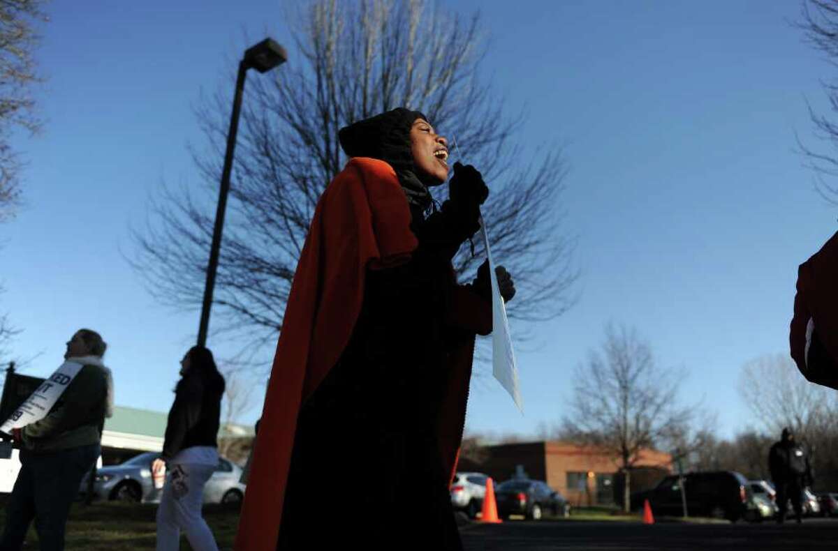 Employee Anisha Outlaw, of West Haven, protests with other members of the New England Health Care Employees Union Tuesday, Dec. 13, 2011 outside West River Health Care Center in Milford, Conn. Employees were locked out for failure to deliver a final contract by October 27, 2011.