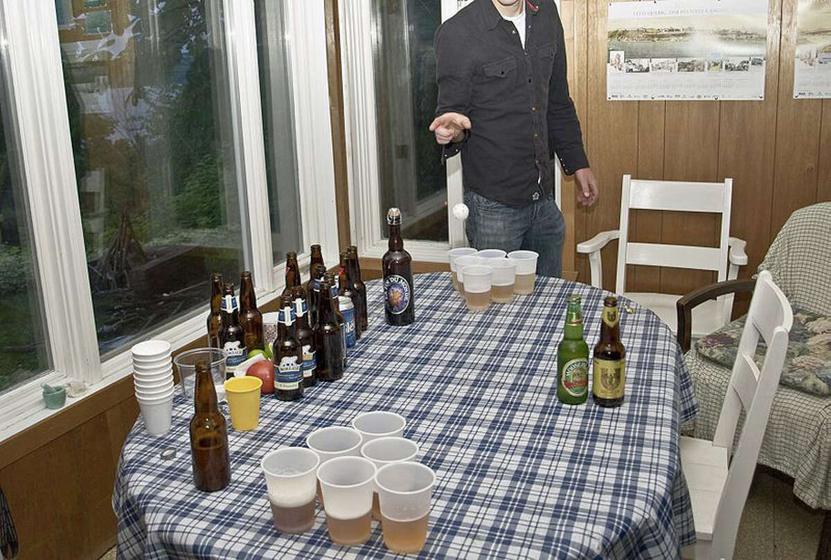 In this file photo, a teen tries his hand at beer pong, a popular drinking game.