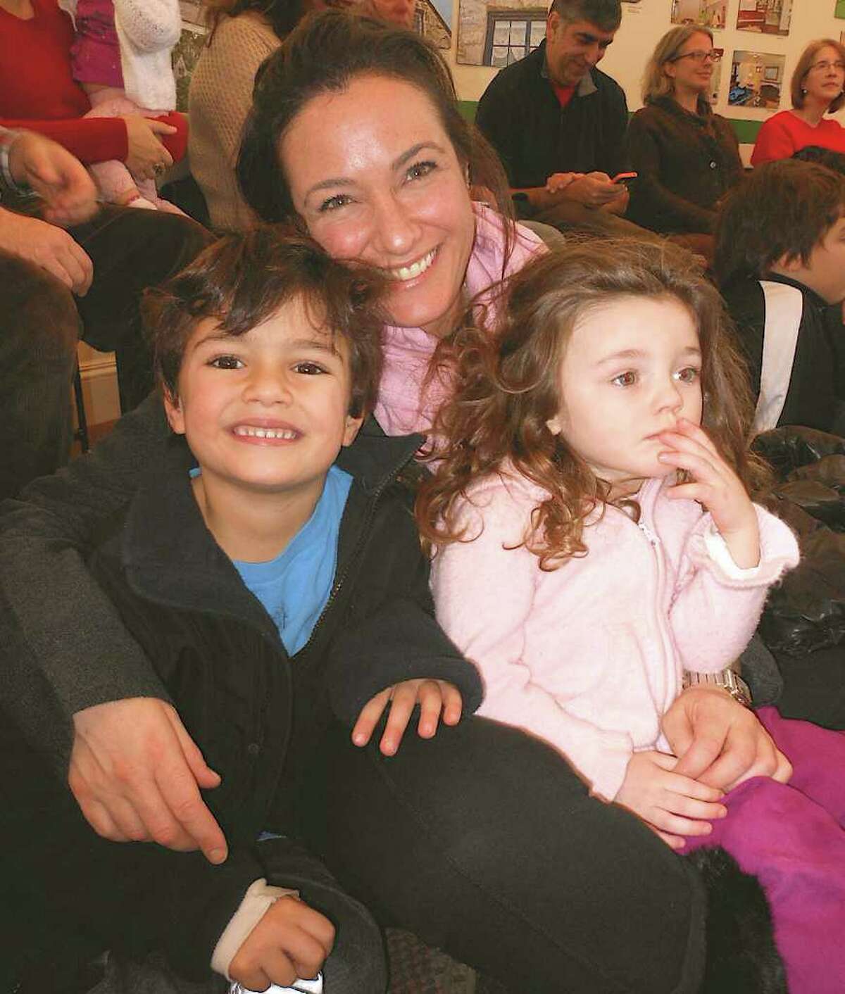 Mother and children enjoy holiday concert Sunday at the Westport Historical Society.