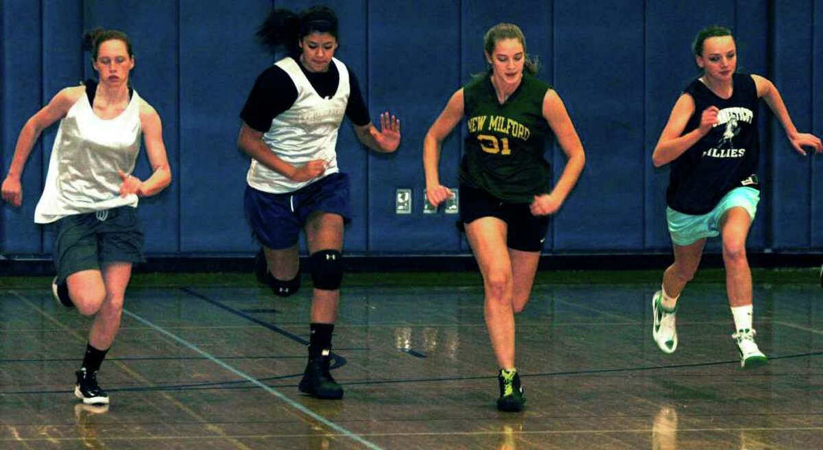 SPECTRUM/Working hard in step with the Green Wave's bid to out-condition its rivals are, from left to right, New Milford High School girls' basketball's Maggie Grubb, Emily Llerena, Allyson LaPorte and Jessica Noteware. December 2011