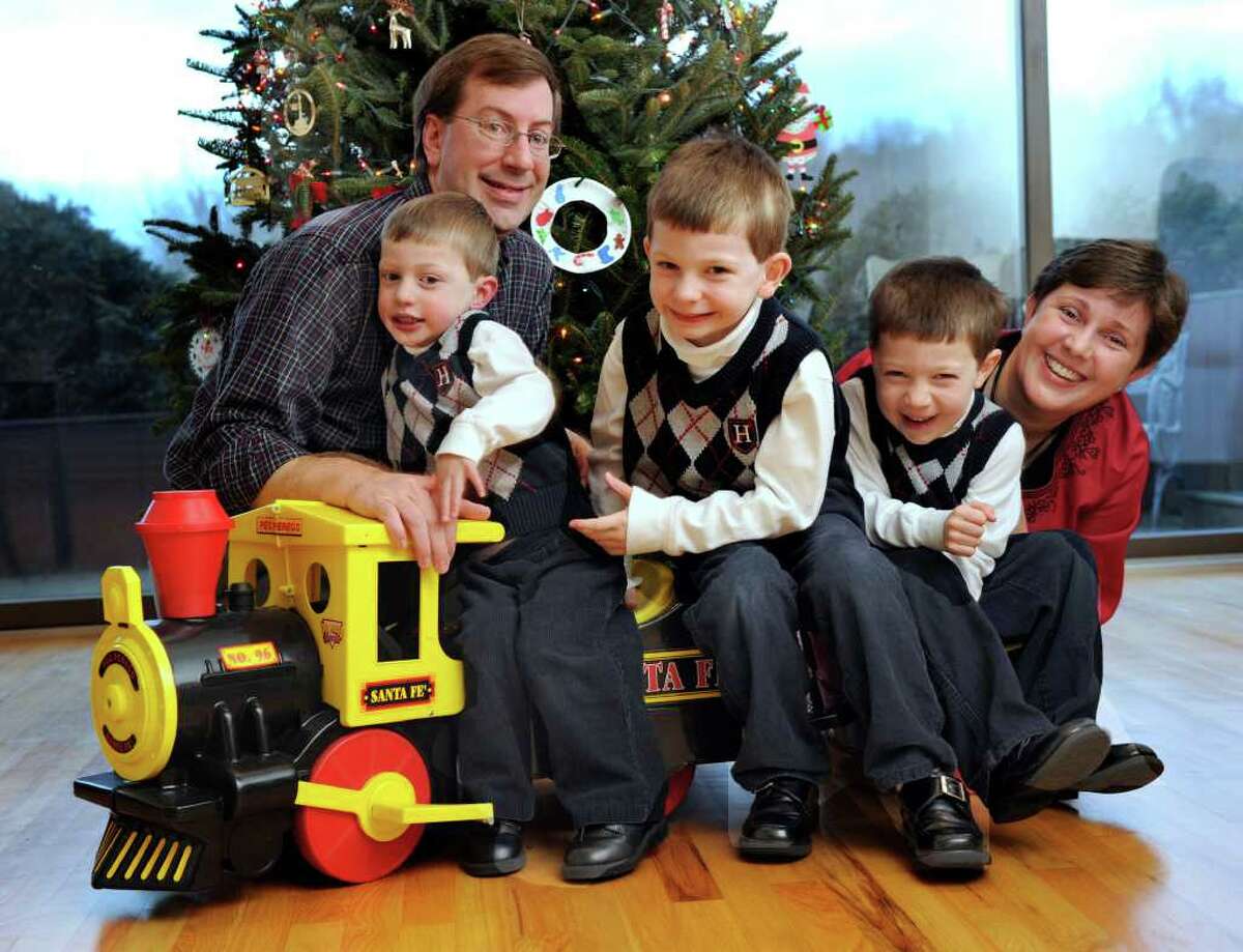 Mike and Marie Hatcher of Sherman with their three sons, from left, Matthew, 3, Michael, 6, and Ryan, 5. Photo taken Wednesday, Dec. 14, 2011.