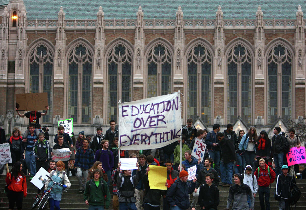 Hundreds of students march on the campus of the University of Washington during a walkout by Seattle area high school students on Wednesday, December 14, 2011. The students gathered at Red Square on the UW campus and marched to protest education cuts proposed by the state government. The march took them from their respective high schools, to the UW campus and then to a building housing the office of State Rep. Frank Chopp.