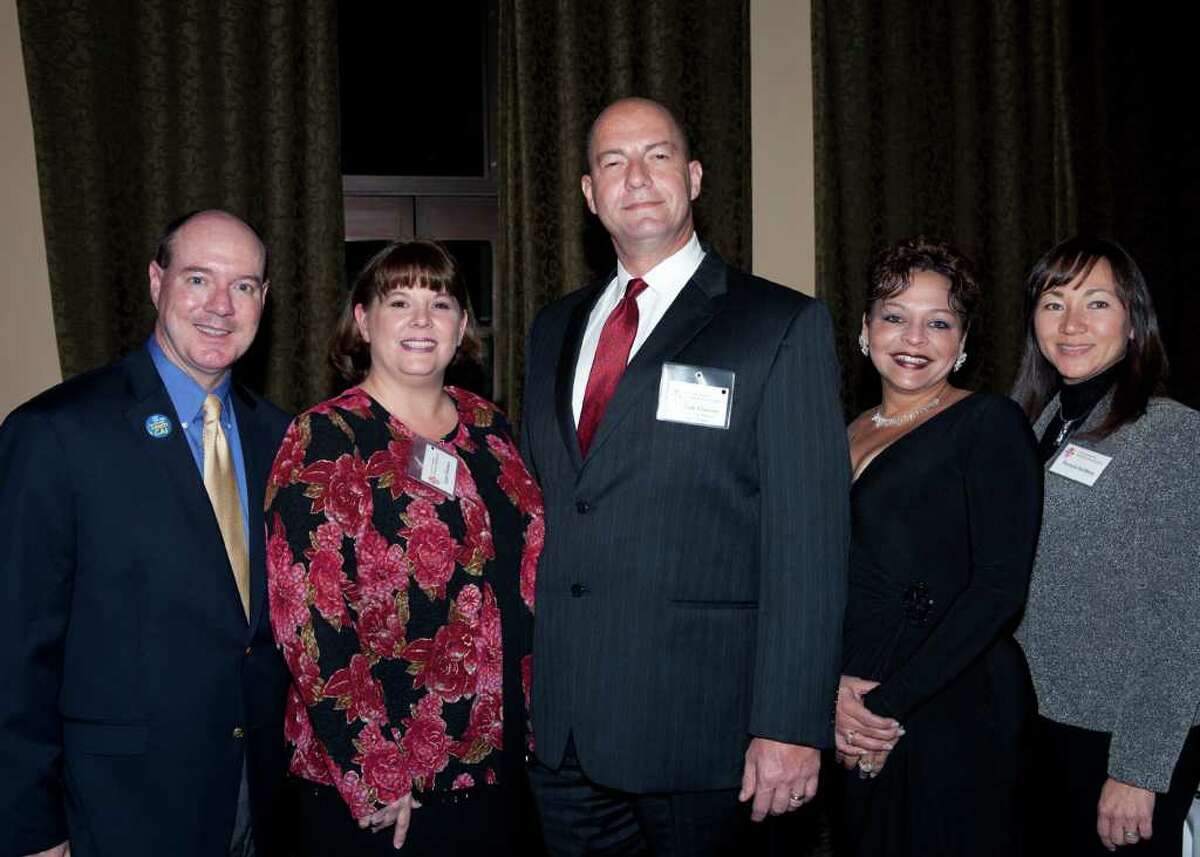 President-elect Brad Bauserman, from left, award winner Lynn Harmon, president Tom Newton, Jr., and award winners Brenda Tate and Patricia Keilberg get together at the Community Associations Institute gala and awards ceremony at The Club at Sonterra. Photo by Jamie Karutz.