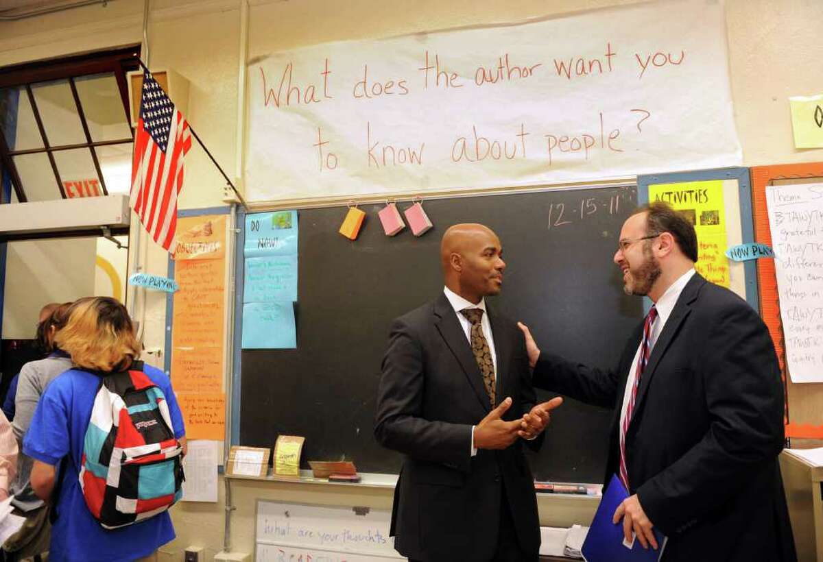 Harding Principal Kevin Walston talks with Commissioner of Education, Stefan Pryor, Thursday, Dec. 15, 2011 during a visit to Bridgeport to see if federal School Improvement Grant money is being spent well. Global parntership, a private company, is getting $2.1 million to improve Harding.