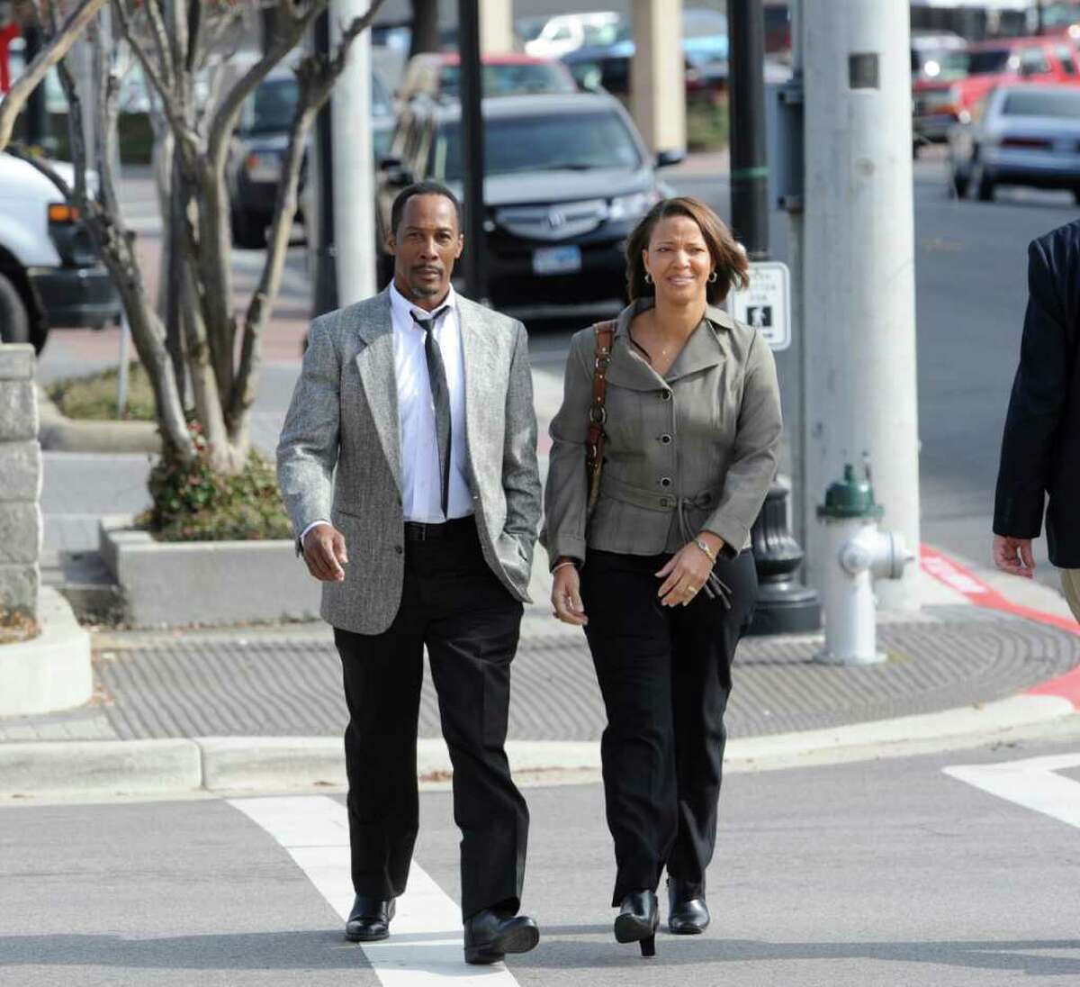 Calvin Walker, left, the Beaumont school district's electrician of record, and his wife Stacey, right, come back from lunch Monday afternoon December 12, heading to the main entrance of the Federal Courthouse. Walker is charged with fraud and overbilling the Beaumont Independent School District. Dave Ryan/The Enterprise