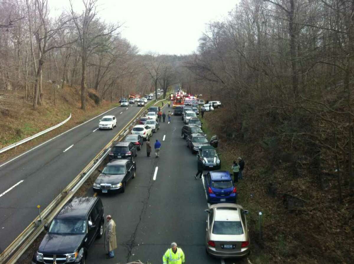 Greenwich firefighters and other emergency personnel at the scene of a serious accident near Den Road on the northbound side of the Merrit Parkway on Thursday, Dec. 15, 2011.