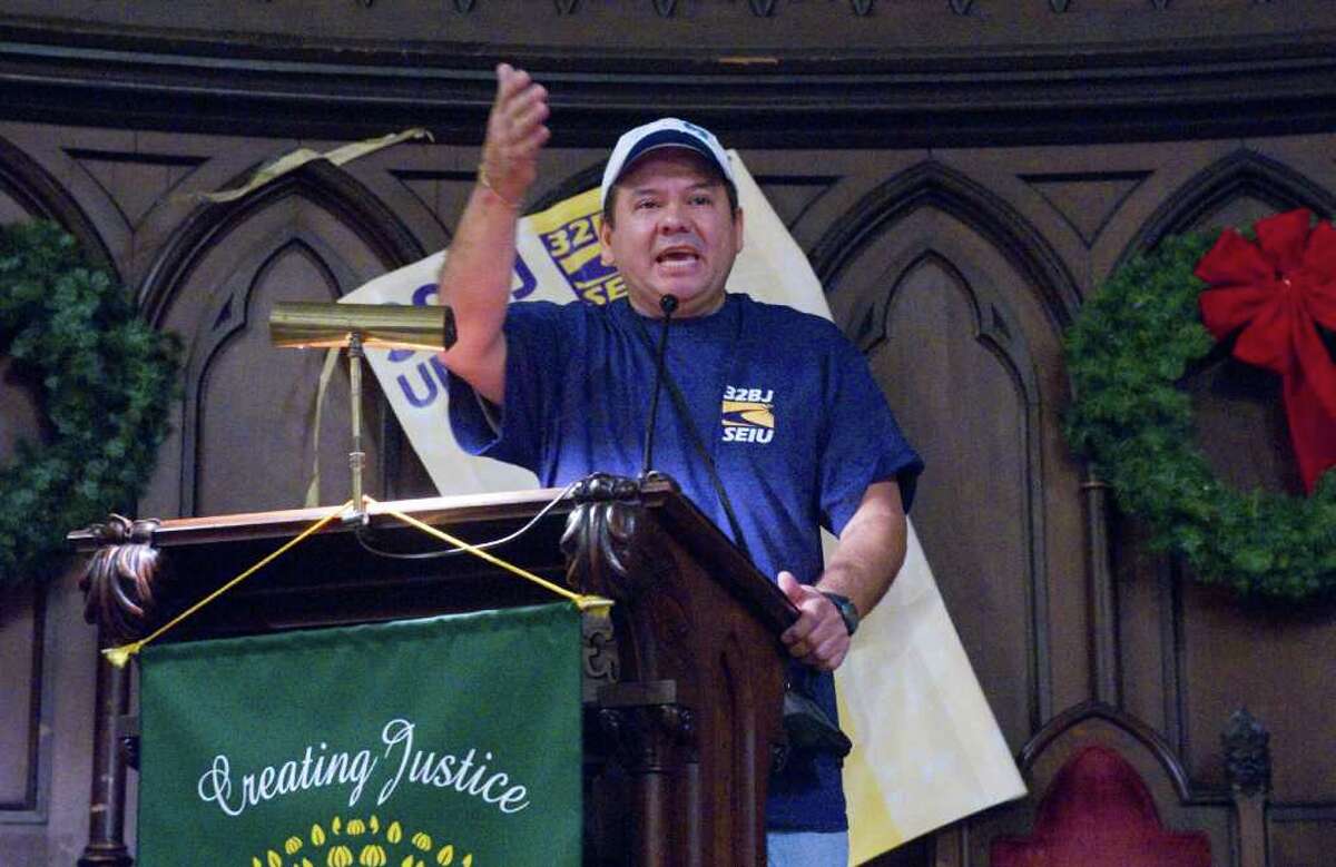 Leonel Arenes addresses the hundreds of Fairfield County office cleaners gathered to hold a vote on whether to authorize their union's bargaining committee to call a strike at the Unitarian Church in Stamford, Conn., December 15, 2011. Negotiations for a new contract covering more than 1,500 commercial office cleaners in Fairfield County and another 1,700 cleaners in Hudson Valley began on November 10th between 32BJ SEIU and representatives for the area's major commercial office building owners, managers, and cleaning companies.32BJ members clean prominent buildings in Fairfield County including the University of Connecticut, the UBS Building, the RBS Building, Norwalk Community College and Fairfield University. The contract is set to expire at 12:01 AM on January 1, 2012.