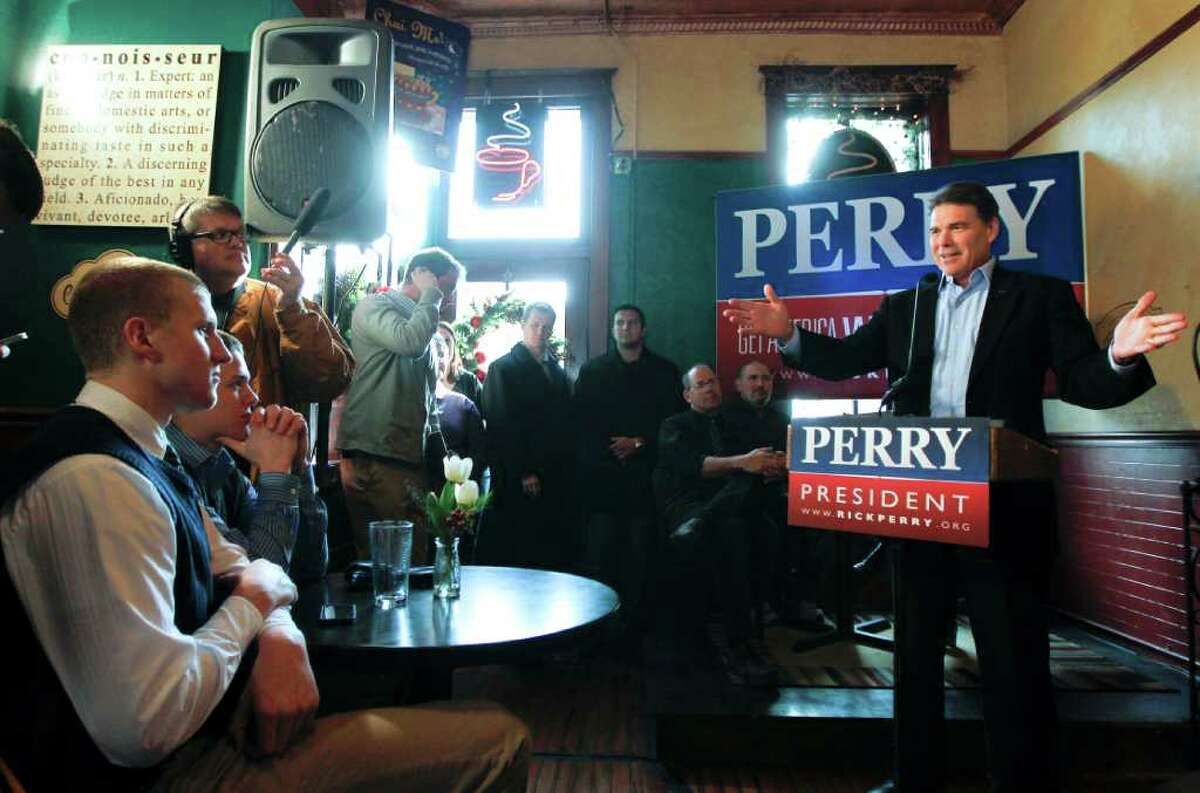 Republican presidential candidate, Texas Gov. Rick Perry speaks during a campaign stop at the Copper Cup Coffee Shop in Cherokee, Iowa, Friday, Dec. 16, 2011. (AP Photo/Chris Carlson)