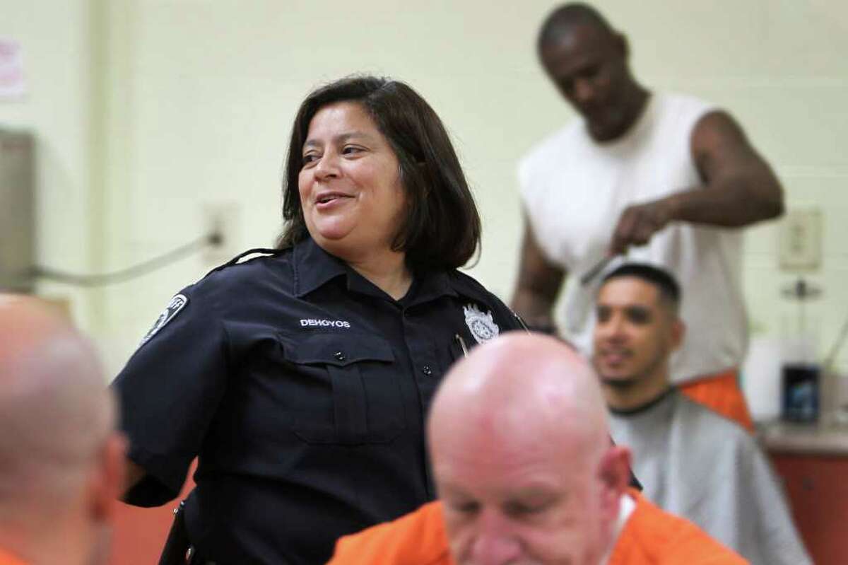 Officer Gloria Dehoyos works one of the units in the Bexar County Jail Annex, Thursday, December 15, 2011. Three months after Commissioners Court approved a 2012 budget that included losing 100 jail guards through attrition, Bexar County detention officers are now working mandatory overtime to man the 140 posts that guard about 3,600 inmates.