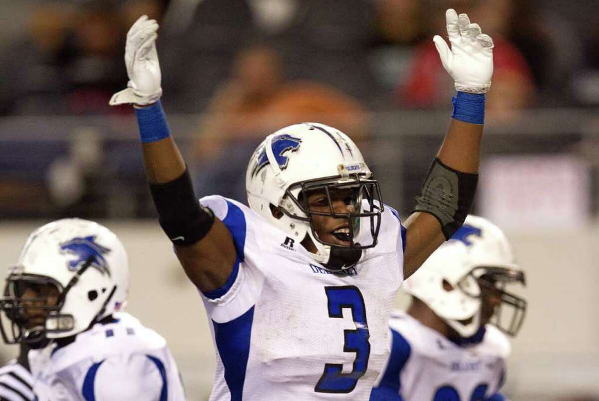 Dekaney running back Trey Williams (3) celebrates after scoring a touchdown just before halftime against Cibolo Steele during the 5A Div. 2 state championship high school football game at Cowboys Stadium on Saturday, Dec. 17, 2011, in Arlington.
