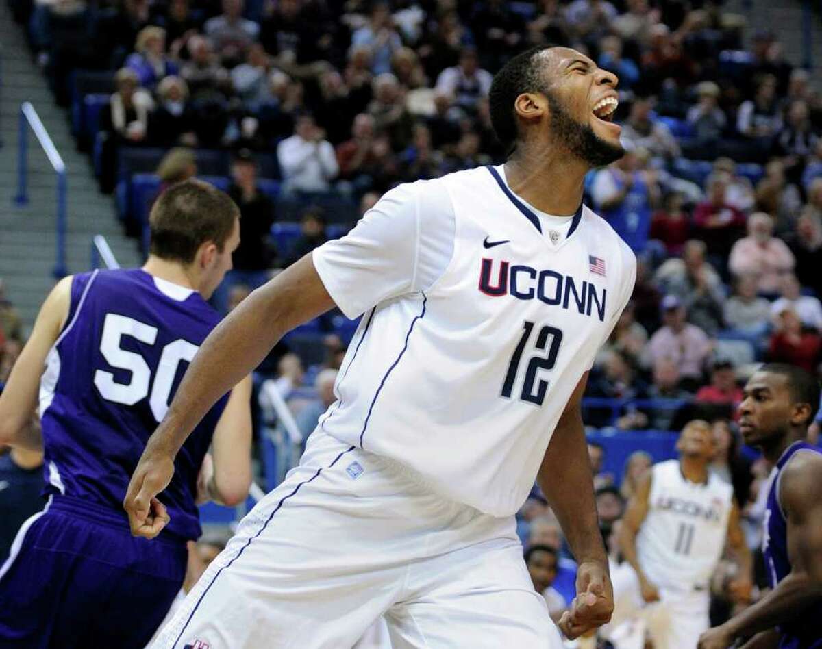 Connecticut's Andre Drummond (12) celebrates during the second half of an NCAA college basketball game in Hartford, Conn., on Sunday, Dec. 18, 2011. Drummond scored a game-high 24 points in his team's 77-40 victory over Holy Cross. (AP Photo/Fred Beckham)