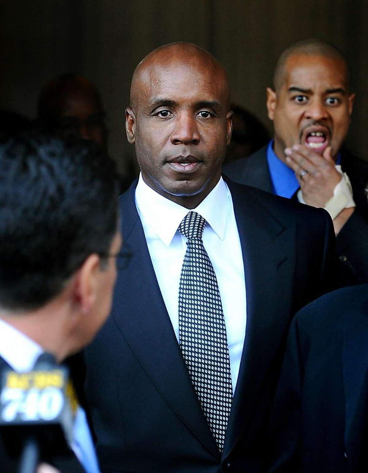 Former baseball player Barry Bonds leaves federal court after being sentenced for obstructing justice in a government steroids investigation on Friday, Dec. 16, 2011, in San Francisco. A federal judge handed Bonds a sentence of 30 days of house arrest, two years of probation and 250 hours of community service, but delayed the sentence pending an appeal likely to take a year or more. (AP Photo/Noah Berger)
