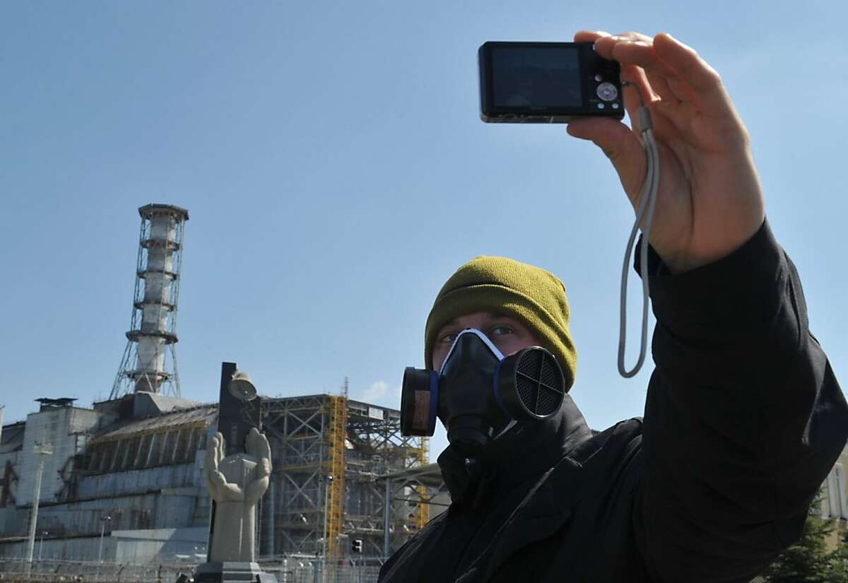 A visitor takes a selfportrait in front of the 4th power block of the Chernobyl Nuclear Power Plant on April 18, 2011. In the heart of Chernobyl, Ukrainian specialists regularly venture inside the concrete cover sheltering the ruined reactor after it exploded on April 26, 1986 to check its structure and radiation levels. AFP PHOTO / SERGEI SUPINSKY (Photo credit should read SERGEI SUPINSKY/AFP/Getty Images) A visitor takes a selfportrait in front of the 4th power block of the Chernobyl Nuclear Power Plant on April 18, 2011. In the heart of Chernobyl, Ukrainian specialists regularly venture inside the concrete cover sheltering the ruined reactor after it exploded on April 26, 1986 to check its structure and radiation levels. AFP PHOTO / SERGEI SUPINSKY (Photo credit should read SERGEI SUPINSKY/AFP/Getty Images)