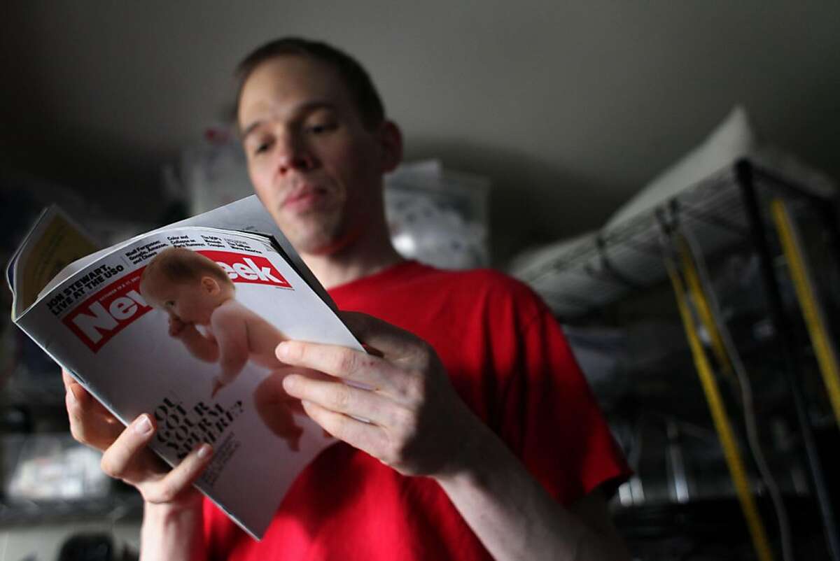 Trent Arsenault, who calls himself a "Donorsexual", reads the story about himself as a sperm donor in a October addition of Newsweek magazine, Thursday December 15, 2011, in Fremont, Calif. He has donated his sperm to dozens of couples over the past six years and fathered over a dozen children all from the bay area.