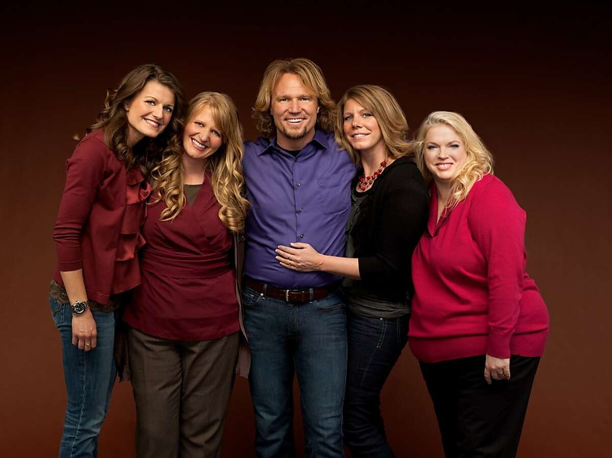 FILE - In this publicity file image provided by TLC, Kody Brown, center, poses with his wives, from left, Robyn, Christine, Meri and Janelle in a promotional photo for the reality series, "Sister Wives." The polygamous family made famous on the TLC show is asking a U.S. judge not to block their challenge of Utah's bigamy law. Kody Brown and wives Meri, Janelle, Christine and Robyn filed a lawsuit in Salt Lake City's U.S. District Court in July 2011. The stars say the law is unconstitutional because it prohibits them from living together and criminalizes their private sexual relationships. (AP Photo/TLC, George Lange, File)