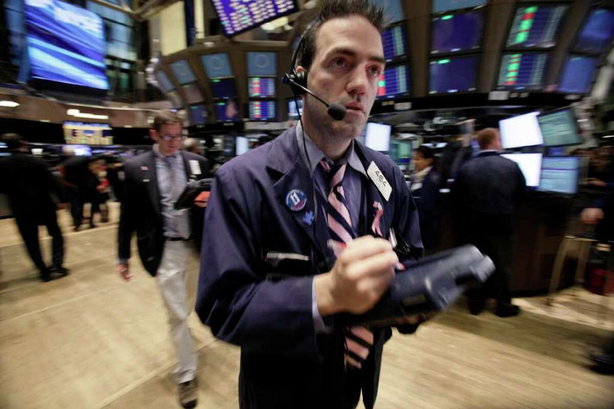 Trader Gregory Rowe works on the floor of the New York Stock Exchange Tuesday, Dec. 20, 2011. Stocks are surging after the opening bell following encouraging signs out of Europe and a jump in apartment building in the U.S. (AP Photo/Richard Drew)