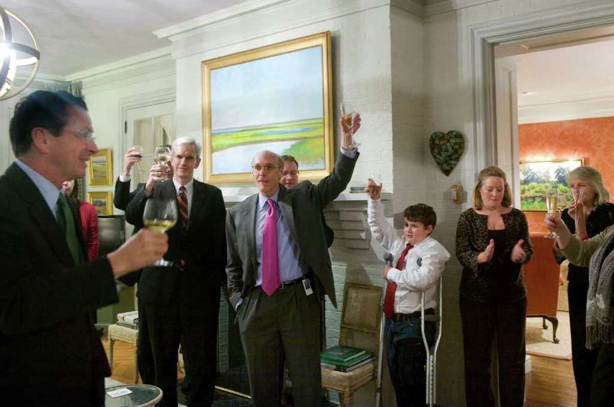 Gov. Dan Malloy leads his staff in a toast after the passage of a bopartisan jobs bill and an incentive package for the Jackson Labratory. The governor and his wife, Cathy, right, hosted a cocktail reception for his staff including Legal Counsel Andrew McDonald, Chief of Staff Tim Bannon, center, and Commissioner of the Connecticut Department of Economic and Community Development Catherine Smith, far right, at the Governor's Mansion in Hartford, Conn., October 27, 2011.
