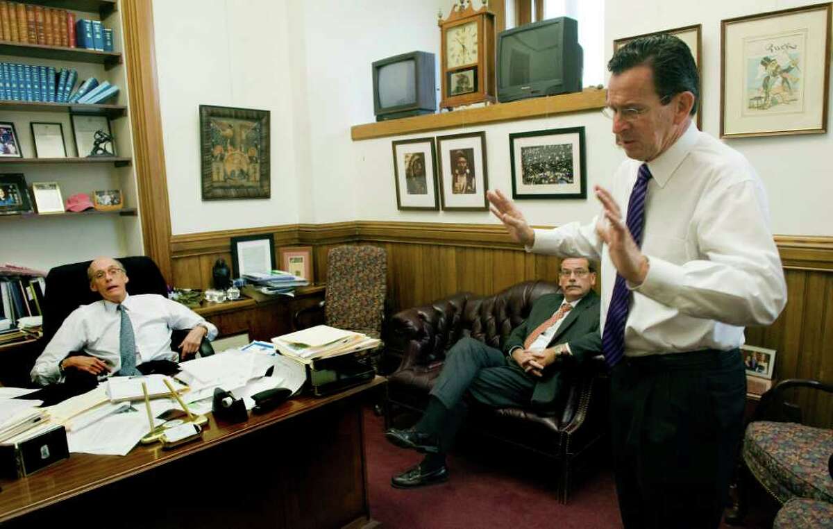 Gov. Dan Malloy meets with Chief of Staff Tim Bannon and Jackson Laboratory's Vice President for Advancement and External Relations Mike Hyde in Bannon's office at the state Capitol in Hartford, Conn., October 26, 2011. Bannon was bullish on the Jackson deal after his wife, Lori Aronson, spotted a newspaper story about their Florida struggles at their house in Bar Harbor, Me.