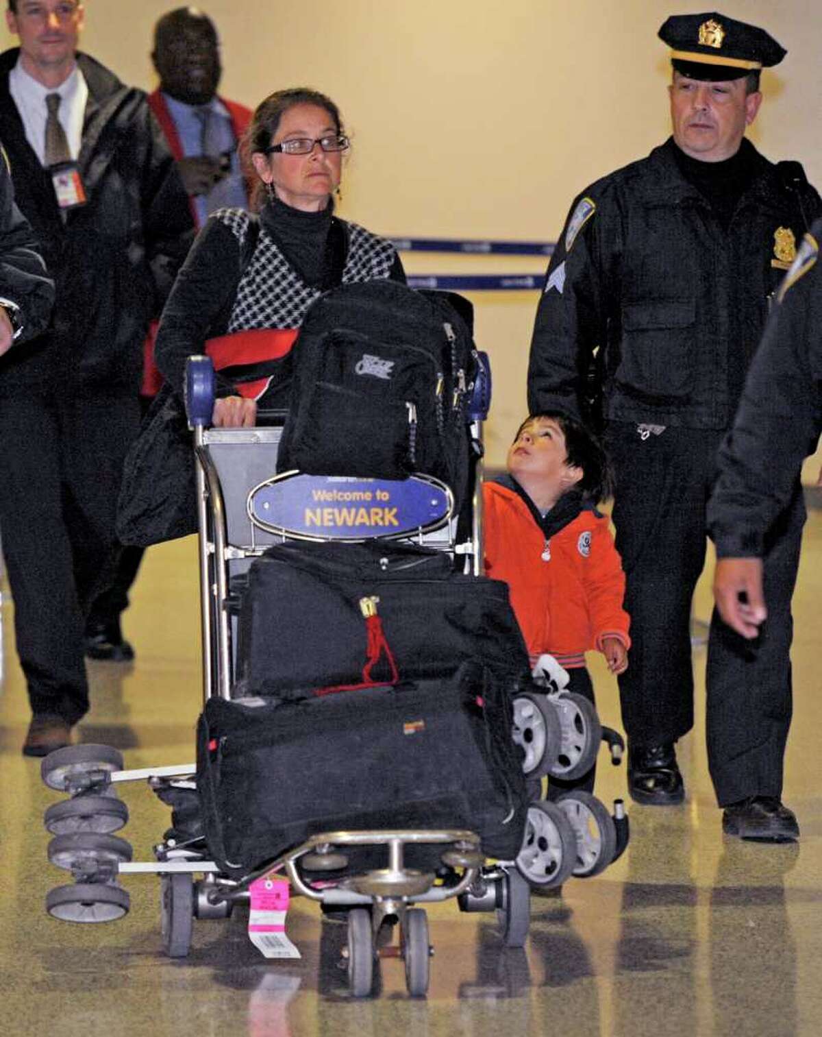 Lori Berenson arrives from Lima, Peru, with her son Salvador Apari at Newark Liberty International Airport, Tuesday, Dec. 20, 2011 in Newark, N.J. Berenson, who was convicted of aiding Peruvian guerrillas and served 15 years before she was paroled last year, said she fully intended to return to Peru by the court-ordered deadline of Jan. 11. (AP Photo/Henny Ray Abrams)