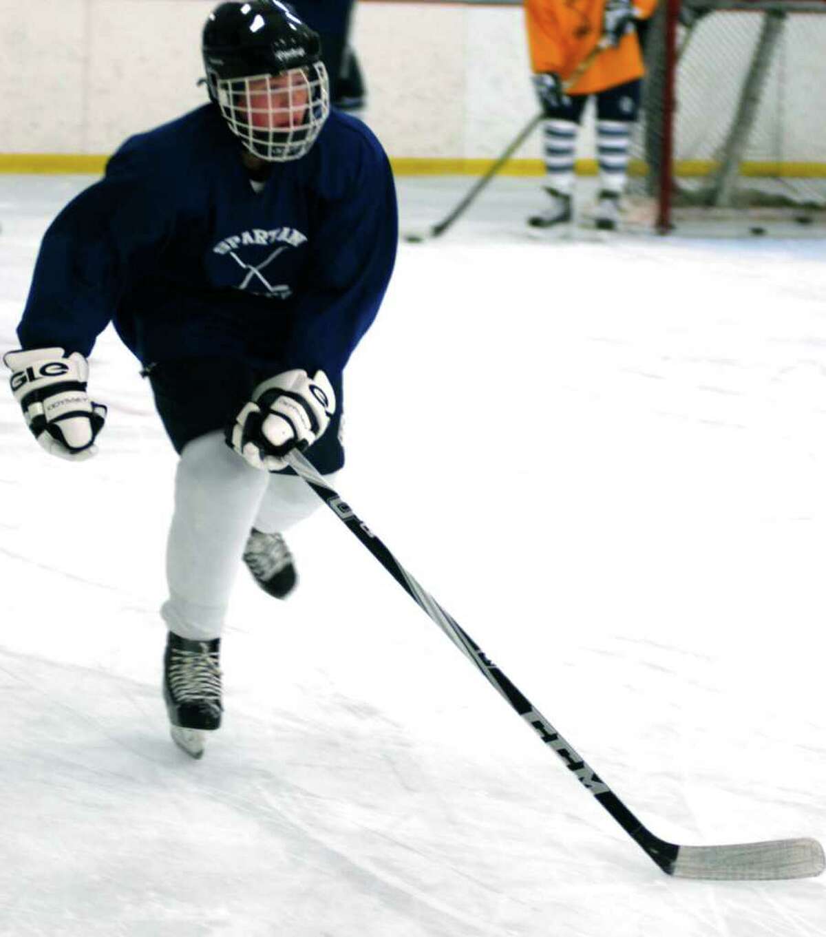 SPECTRUM/Christian Stuart of the Spartans stretches out his stride during pre-season practice for Shepaug Valley High School ice hockey. December 2011