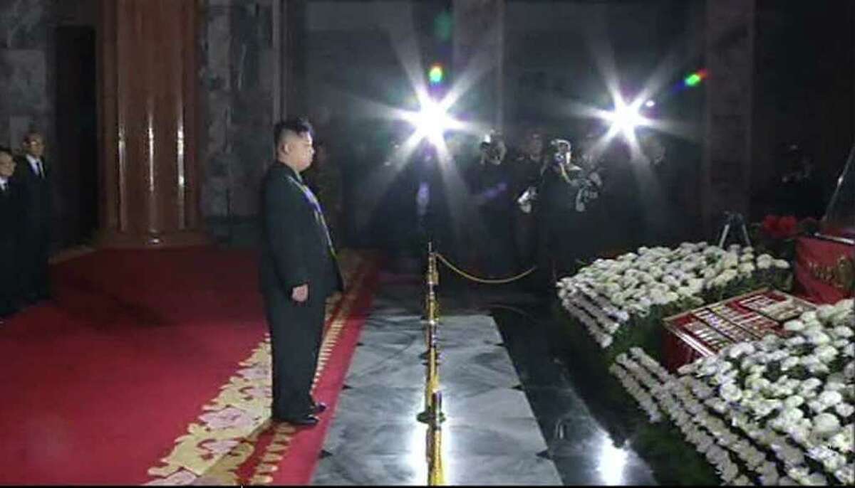 ASSOCIATED PRESS PHOTOS GRIEF STRICKEN: Kim Jong Un, North Korean leader Kim Jong Il's successor, visits the body of his father in Kumsusan mausoleum in Pyongyang on Tuesday. State media said: "Comrade Kim paid his respect with a grief-stricken heart."