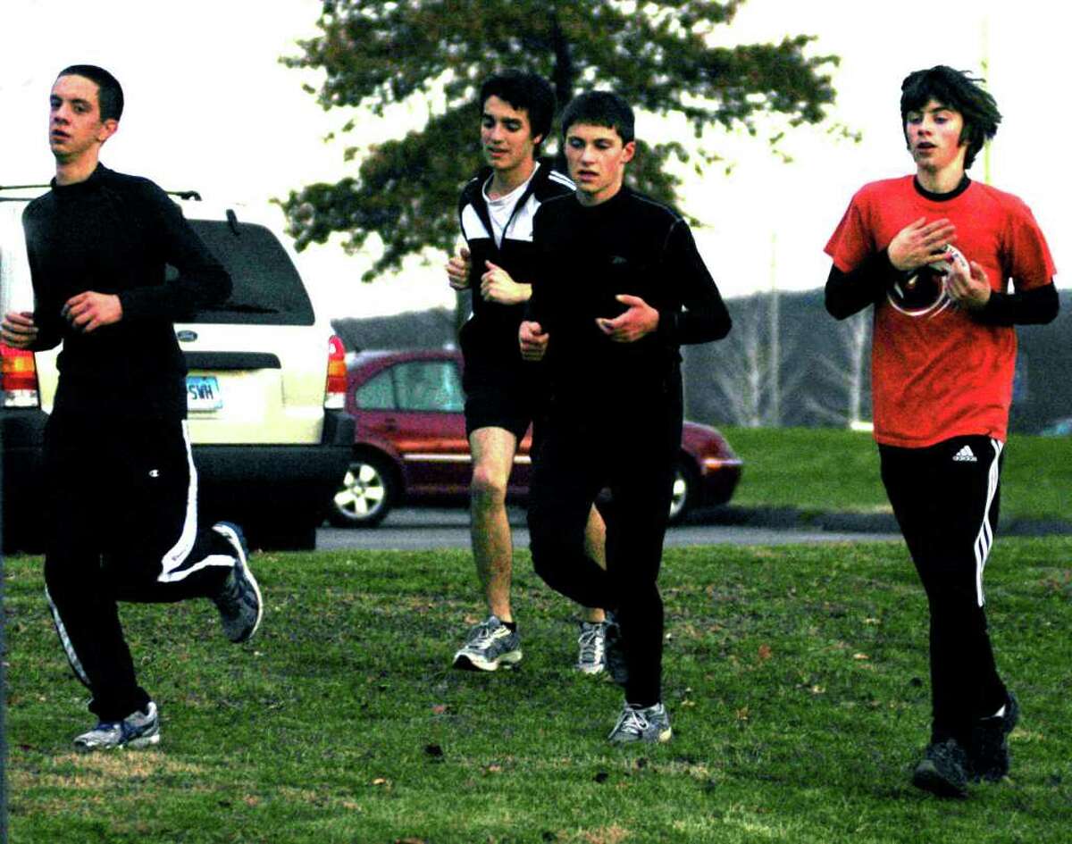 SPECTRUM/Working their way into competitive shape for the Green Wave are, from left to right, Tommy Blackburn, Tyler Swanson, Hugh Sichel and Jay Humphreys of New Milford High School boys' indoor track, December 2011