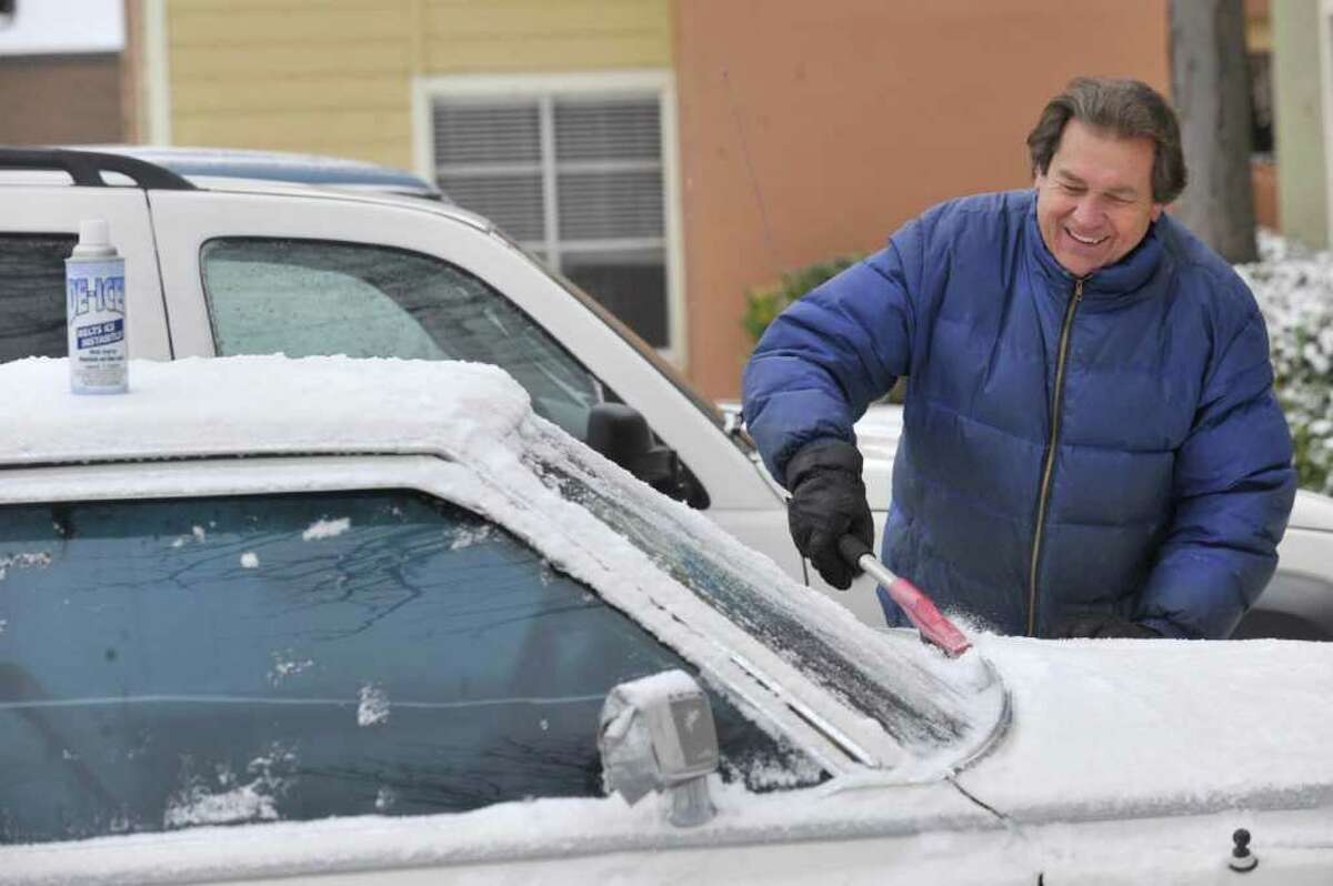 MICHAEL SCHUMACHER: ASSOCIATED PRESS/AMARILLO GLOBE-NEWS COLD CLEANUP: Sam Konkol clears his windshield Tuesday morning in Amarillo. Crews were able to reopen interstates in Texas, Oklahoma and Kansas closed by high drifts.