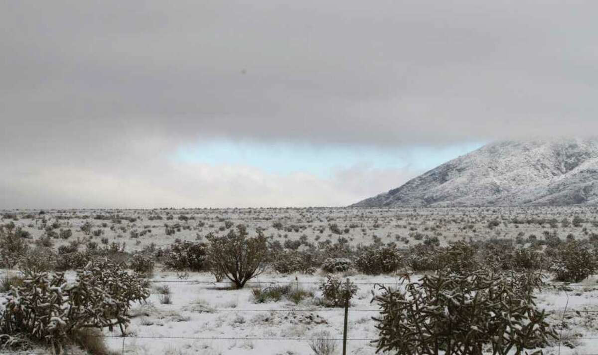 Fog begins to lift from the Sandia Mountains near Albuquerque, N.M., on Tuesday, Dec. 20, 2011, after a major winter storm moved through the state. New Mexico highway officials say they are mopping up and getting major thoroughfares reopened. (AP Photo/Susan Montoya Bryan)